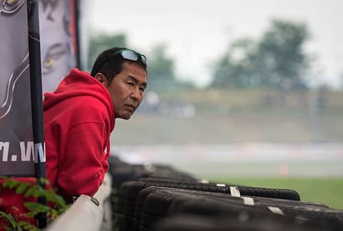 keiichi tsuchiya leaning at track