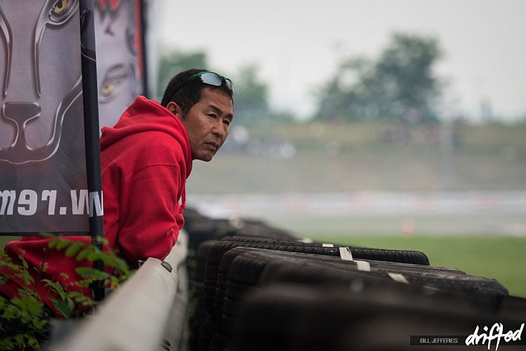 keiichi tsuchiya leaning at track