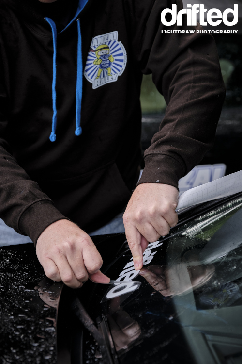 applying sticker to windshield