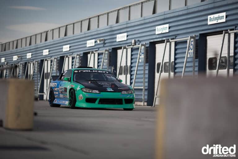The Ultimate Guide For Transporting Your Race Car - Image nissan silvia s15 at racetrack garages
